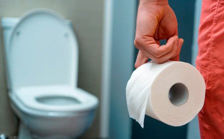 Девушка стоит возле туалета